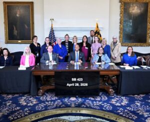 An image of Maryland Governor, Wes Moore, signing SB 423.